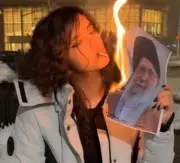 Iranian Women Defy Regime, Burn Supreme Leader's Photo to Light Cigarettes