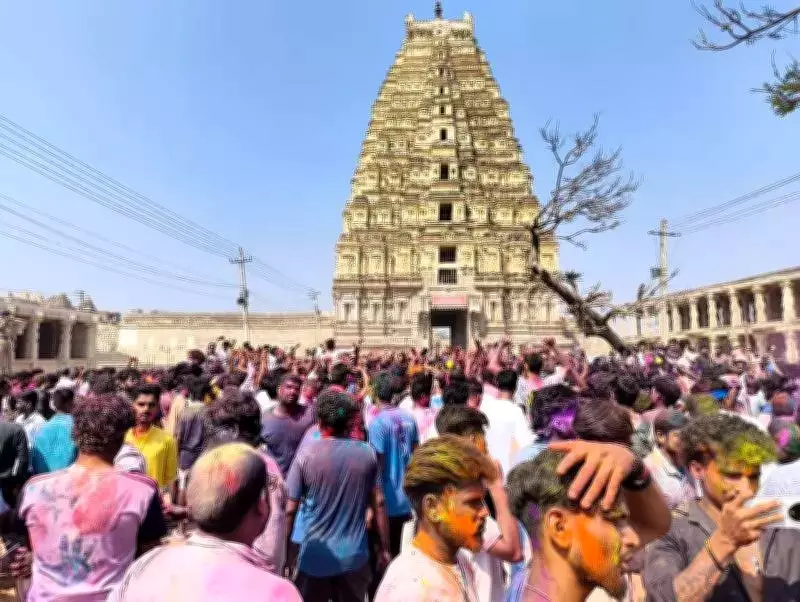 Foreign Tourists Join Hampi's Holi Celebrations at UNESCO Heritage Site