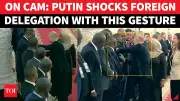 Putin Adjusts Tanzanian Official's Badge During Moscow Ceremony
